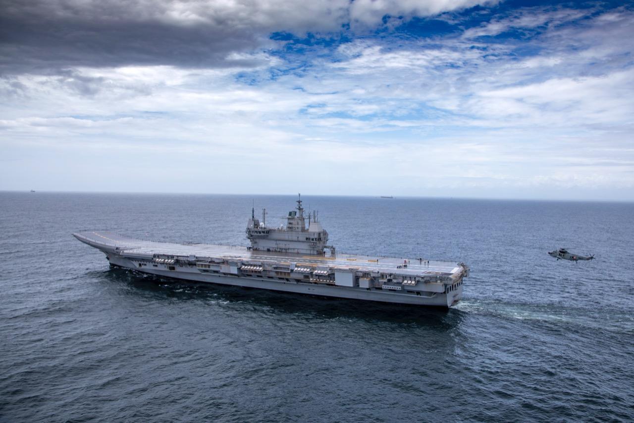 Indian Navy helicopter landing on aircraft carrier INS Vikrant during sea trials